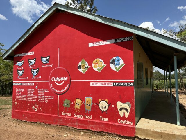 A Colgate-sponsored mural on a Kenyan school wall illustrates oral hygiene in the educational primary school setting. As a CSR-partnership Colgate sponsors Safe Water Access fulfilled by WellBoring in rural Kenya.