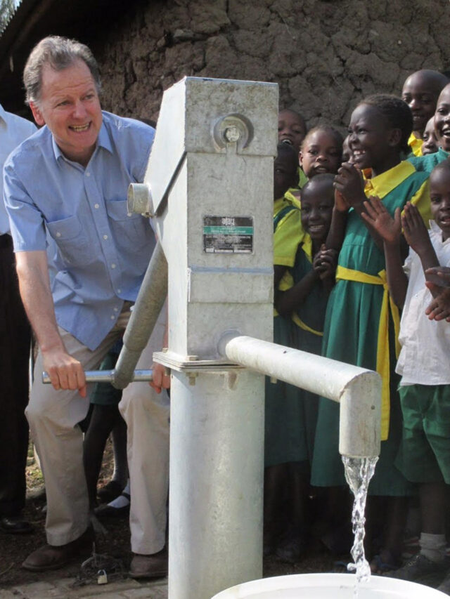 Nigel Linacre, dedicated to fostering government partnerships, operates a newly installed hand pump at an African primary school.