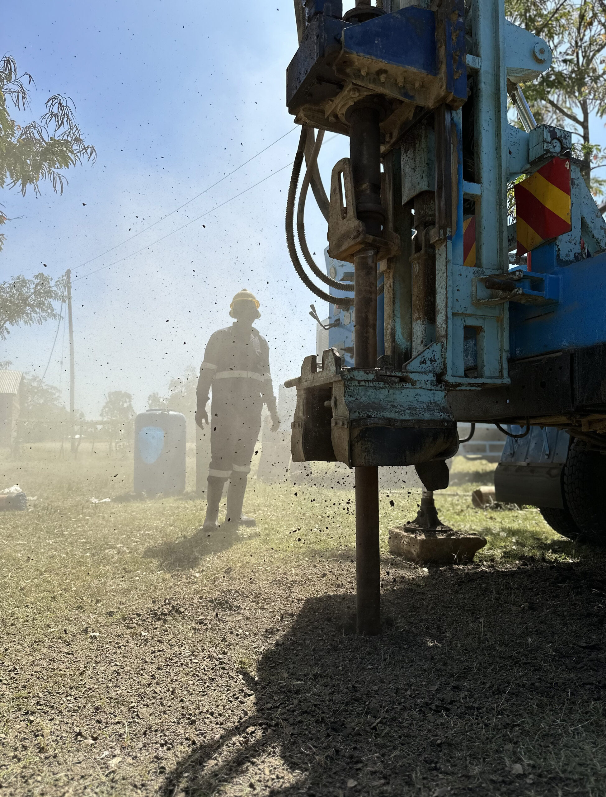 A drilling rig pierces the earth at a school for the hearing impaired in Kenya, beginning the process of constructing a solar-powered groundwater well.